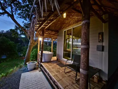 a deck with a bath tub and a house at Krabi Sea View Orchid Beach room in Krabi town