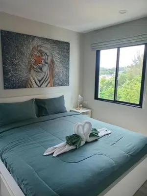 a bedroom with a bed with a painting of a tiger at В10 Title 2-bedroom 86м2 ВатСaп66935B2I976 in Nai Yang Beach