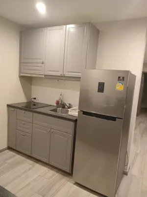 a kitchen with white cabinets and a stainless steel refrigerator at В10 Title 2-bedroom 86м2 ВатСaп66935B2I976 in Nai Yang Beach