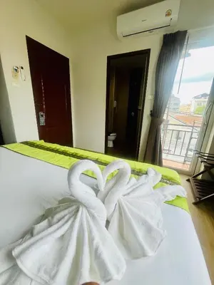 two white swans sitting on top of a bed at 28 Boutique Hotel - Newly Renovated in Patong Beach