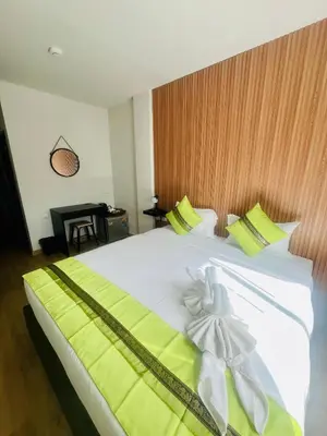 a bedroom with a large white bed with a bow on it at 28 Boutique Hotel - Newly Renovated in Patong Beach