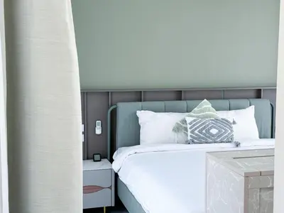 a bedroom with a bed with white sheets and pillows at Townhouse Bellano 3BR FamilyLaguna Park Bang Tao in Laguna Phuket