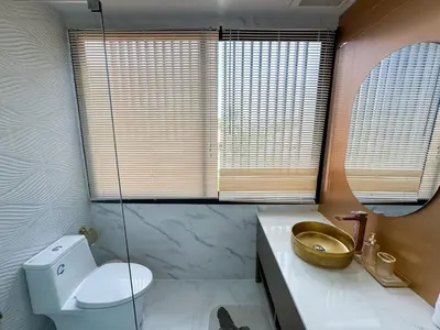 a bathroom with a toilet and a sink and a mirror at Townhouse Bellano 3BR FamilyLaguna Park Bang Tao in Laguna Phuket