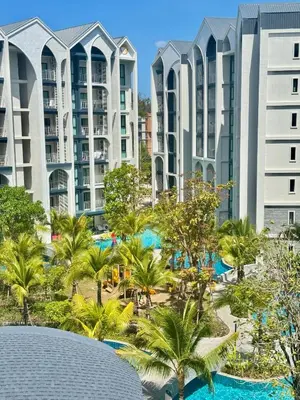 an image of a resort with palm trees and buildings at 1BR Title Halo at Naiyang beach in Nai Yang Beach