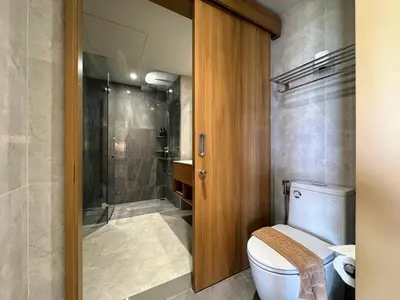a bathroom with a toilet and a shower at Laguna Beachside Residences by Beringela in Bang Tao Beach