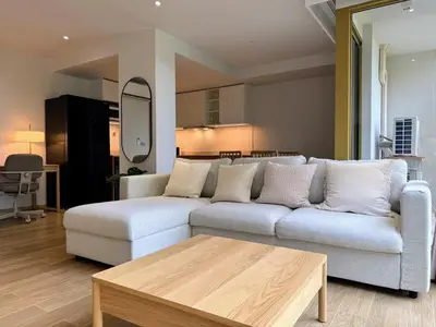 a living room with a couch and a coffee table at Laguna Beachside Residences by Beringela in Bang Tao Beach