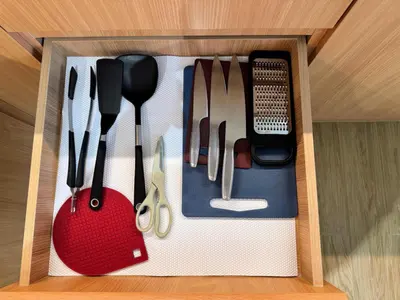a drawer filled with utensils in a wooden box at Laguna Beachside Residences by Beringela in Bang Tao Beach