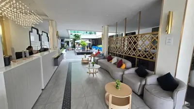 a lobby with couches and tables in a building at Chalong Marina Bay View by SP in Ban Bang Chak