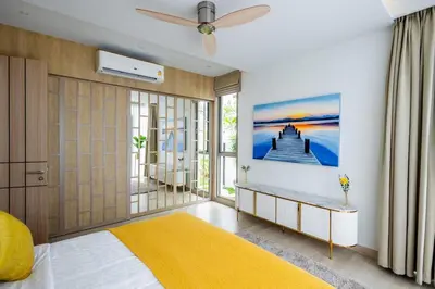 a bedroom with a bed and a ceiling fan at Khanaen Luxury Pool Villa by SP in Ban Chin Tham Mai