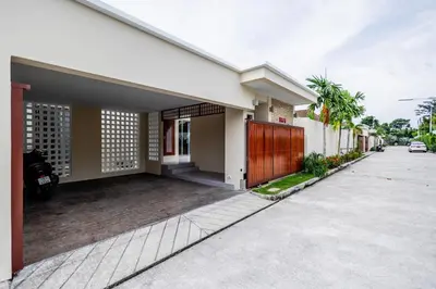 a house with a driveway in front of it at Khanaen Luxury Pool Villa by SP in Ban Chin Tham Mai