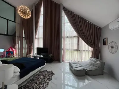 a bedroom with a bed and a couch and windows at The Granary Villas by SP in Ban Pak Lak