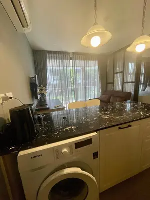 a kitchen with a washing machine in a room at The Palmirah Surin by SP in Surin Beach