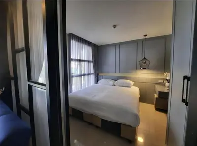 a bedroom with a bed and a window at The Palmirah Surin by SP in Surin Beach