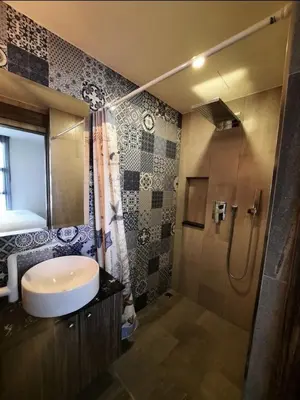 a bathroom with a sink and a shower at The Palmirah Surin by SP in Surin Beach