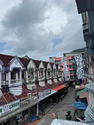 a row of buildings on a street in a city at Sundiva Guest House in Patong Beach