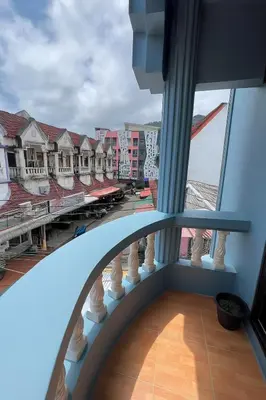 a view from the balcony of a building with a train at Sundiva Guest House in Patong Beach