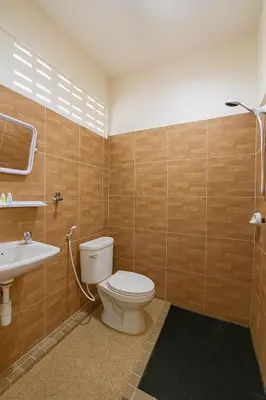 a bathroom with a toilet and a sink at Sundiva Guest House in Patong Beach