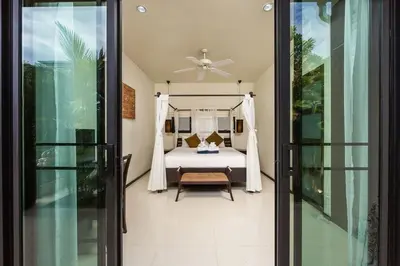a bedroom with a bed and a ceiling fan at Villa Haeata 3BR Private Pool Nai Harn Beach in Nai Harn Beach