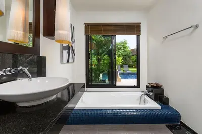 a bathroom with a white tub and a sink at Villa Haeata 3BR Private Pool Nai Harn Beach in Nai Harn Beach
