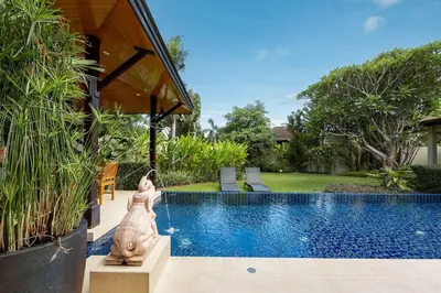 a swimming pool with a statue next to a house at Villa Haeata 3BR Private Pool Nai Harn Beach in Nai Harn Beach