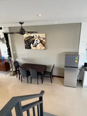 a dining room with a table and chairs at Rawai Seaview Pool Townhouse in Rawai Beach