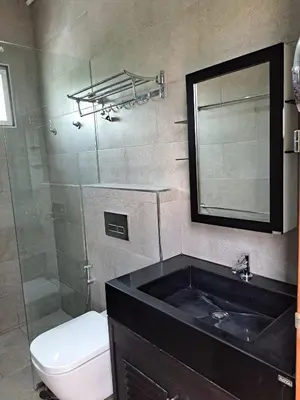 a bathroom with a sink and a toilet and a mirror at Rawai Seaview Pool Townhouse in Rawai Beach