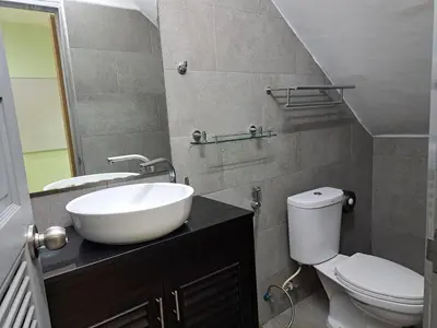 a bathroom with a white sink and a toilet at Rawai Seaview Pool Townhouse in Rawai Beach