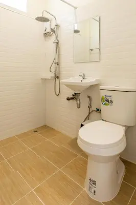 a bathroom with a toilet and a sink at Homehug in Ban Thalat Choeng Thale