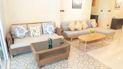 a living room with a couch and a table at Jaokhun Hilltop Patong, Phuket in Patong Beach
