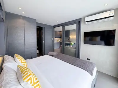 a bedroom with a large white bed and a tv at Amazing 1Bdr Kamala City Gate 3 Pools, Coworking in Kamala Beach