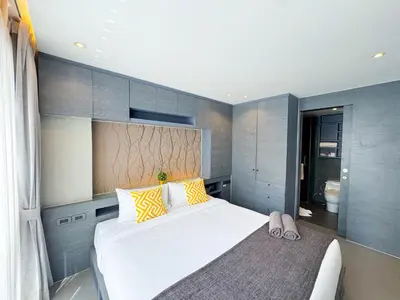 a bedroom with a large white bed and a bathroom at Amazing 1Bdr Kamala City Gate 3 Pools, Coworking in Kamala Beach