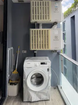 a laundry room with a washing machine and boxes on the wall at Amazing 1Bdr Kamala City Gate 3 Pools, Coworking in Kamala Beach