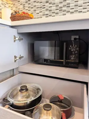 two pots and pans on a stove in a kitchen at Amazing 1Bdr Kamala City Gate 3 Pools, Coworking in Kamala Beach