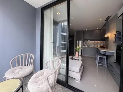 a living room with two chairs and a kitchen at Amazing 1Bdr Kamala City Gate 3 Pools, Coworking in Kamala Beach
