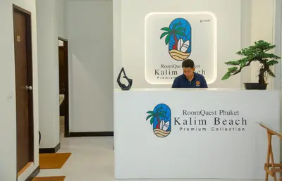 a man standing behind a counter in a room at RQ Phuket Kalim Beach Blue Horizon in Patong Beach