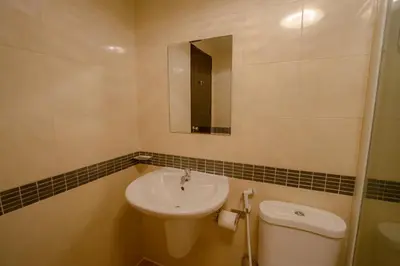 a bathroom with a sink and a toilet and a mirror at RQ Phuket Kalim Beach Blue Horizon in Patong Beach