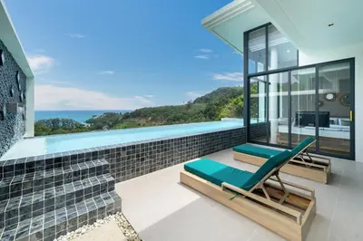 a house with a swimming pool and a chaise lounge at The Exclusive Sky D1 \u8c6a\u534e4\u5367\u5ba4\u6d77\u666f\u522b\u5885 \u79c1\u4eba12m\u65e0\u8fb9\u6d77\u666f\u6cf3\u6c60 \u6bcf\u65e5\u6e05\u6d01 in Kamala Beach