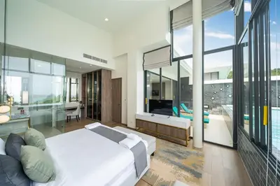 a bedroom with a large white bed and a balcony at The Exclusive Sky D1 \u8c6a\u534e4\u5367\u5ba4\u6d77\u666f\u522b\u5885 \u79c1\u4eba12m\u65e0\u8fb9\u6d77\u666f\u6cf3\u6c60 \u6bcf\u65e5\u6e05\u6d01 in Kamala Beach