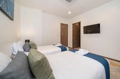 two beds in a room with a couch and a tv at The Exclusive Sky D1 \u8c6a\u534e4\u5367\u5ba4\u6d77\u666f\u522b\u5885 \u79c1\u4eba12m\u65e0\u8fb9\u6d77\u666f\u6cf3\u6c60 \u6bcf\u65e5\u6e05\u6d01 in Kamala Beach