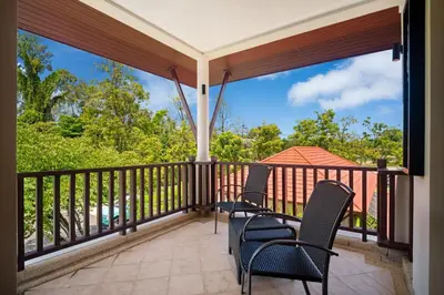 a balcony with chairs and a view of the water at Laguna Village 2 Bedroom Pool View Villa by Banyan Living in Layan Beach