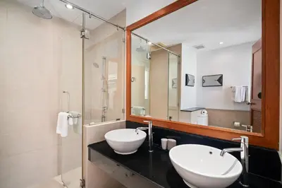 a bathroom with two sinks and a large mirror at Laguna Village 2 Bedroom Pool View Villa by Banyan Living in Layan Beach