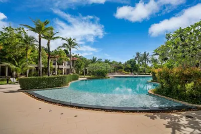 a swimming pool at a resort with palm trees at Laguna Village 2 Bedroom Pool View Villa by Banyan Living in Layan Beach
