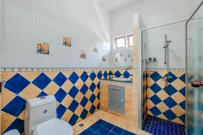 a bathroom with a toilet and a shower at Tranquility Haven Villa, Kata Beach in Kata Beach