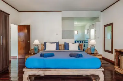 a large blue bed with two blue pillows on it at Tranquility Haven Villa, Kata Beach in Kata Beach