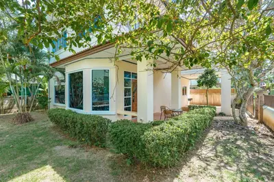 a house with a hedge in front of it at Tranquility Haven Villa, Kata Beach in Kata Beach
