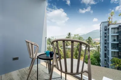 a table and two chairs on a balcony with a view at Tropical Kamala Hill View 1 BR CTG P407 in Kamala Beach