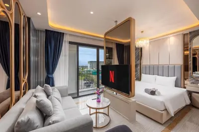 a hotel room with a bed and a tv at Bellevue Lagoon Premium Apart Hotel by TropicLook in Bang Tao Beach