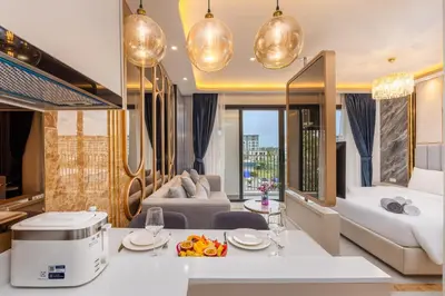 a living room with a couch and a table at Bellevue Lagoon Premium Apart Hotel by TropicLook in Bang Tao Beach