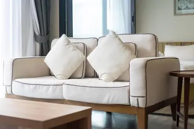 a white couch with pillows on it in a living room at Holiday apartment at The Deck by Lofty in Patong Beach