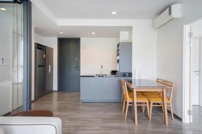 a kitchen and dining room with a table and chairs at Holiday apartment at The Deck by Lofty in Patong Beach